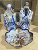 A pair of Oriental style figures togethe