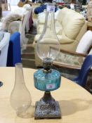 A 19th century oil lamp with blue glass
