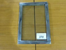 A white metal photo frame with unusual h