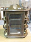 A small wall mounted display cabinet wit