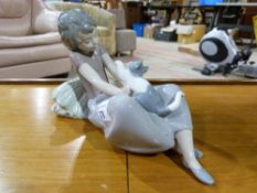 A Lladro figure of a girl playing with a