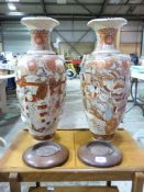 A large pair of oriental vases on wooden