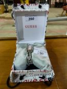 A cased Guess ladies watch with pink opa