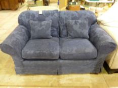A blue two seater sofa