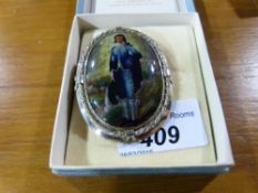 A cased white metal brooch 