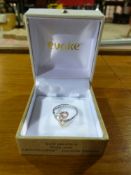 A white metal triple heart ring stamped