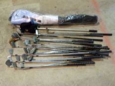 A quantity of various golf clubs togethe
