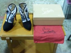 A boxed pair of Christian Louboutin shoe
