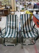 Two green striped garden loungers and a