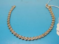 A 9ct gold tennis bracelet set with diam