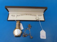 A silver charm bracelet with five teddy