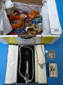 A collection of beaded necklaces, brooch