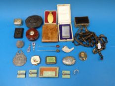 A white metal money clip, filigree brooc