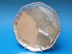 A hallmarked silver card tray with shape