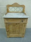 A marble-topped wash stand with tiled ba