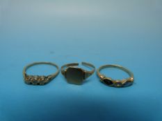 A 9ct gold ring set with three diamonds,