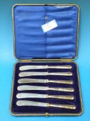 A cased set of six silver handled butter