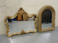 A wicker frame mirror and an ornate mirr