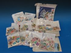 A large quantity of loose stamps sorted