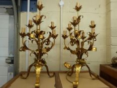 A pair of foliate gilt lamps and another