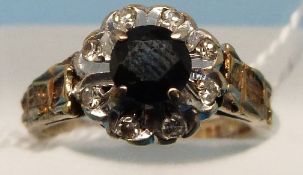 A 9ct gold ring set with a central sapph