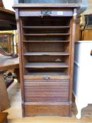 An oak tambour fronted filing cabinet wi