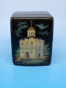 A Russian lacquer box decorated with a c