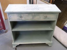 A painted bookshelf with two drawers abo