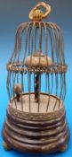 A novelty bird cage clock with moving bi