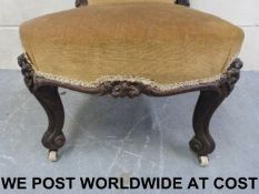 A 19thC carved walnut nursing chair