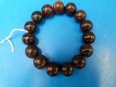 A bracelet of 15 rhinoceros horn beads,