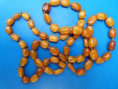 An amber necklace comprising 63 barrel s