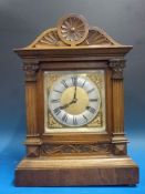 A beechwood-cased bracket style mantel c