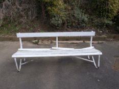 A wrought iron bench with wooden slats,