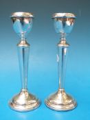 A pair of hallmarked silver candle stick