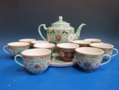 An Oriental style tea pot and cups in tu