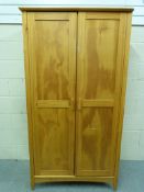 A small two door pine wardrobe (W95.5cm