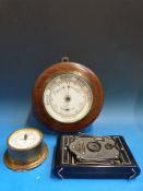 An aneroid barometer, a smaller marine e