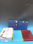 A box of first day covers, in four album