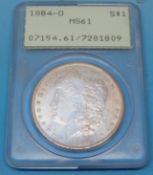 A cased 1884 US Morgan dollar