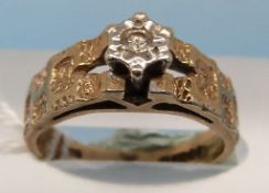 A 9ct gold ring set with a diamond in an