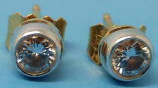 A pair of 18ct gold earrings set with ro