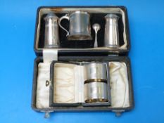 A cased hallmarked silver cruet set toge