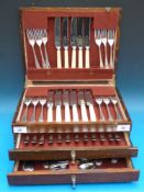 An oak-cased silver plated canteen of cu