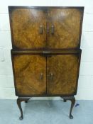 A burr walnut drinks cabinet raised on c