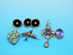 A silver pendant set with an amethyst an