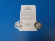 Two silver Britannia coins, one for 2004