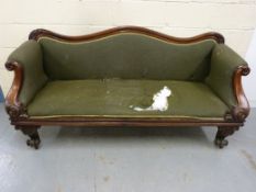 A Victorian upholstered sofa with scroll