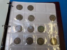 A collection coin folder containing UK c