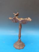 A cast metal bird bath in the form of a